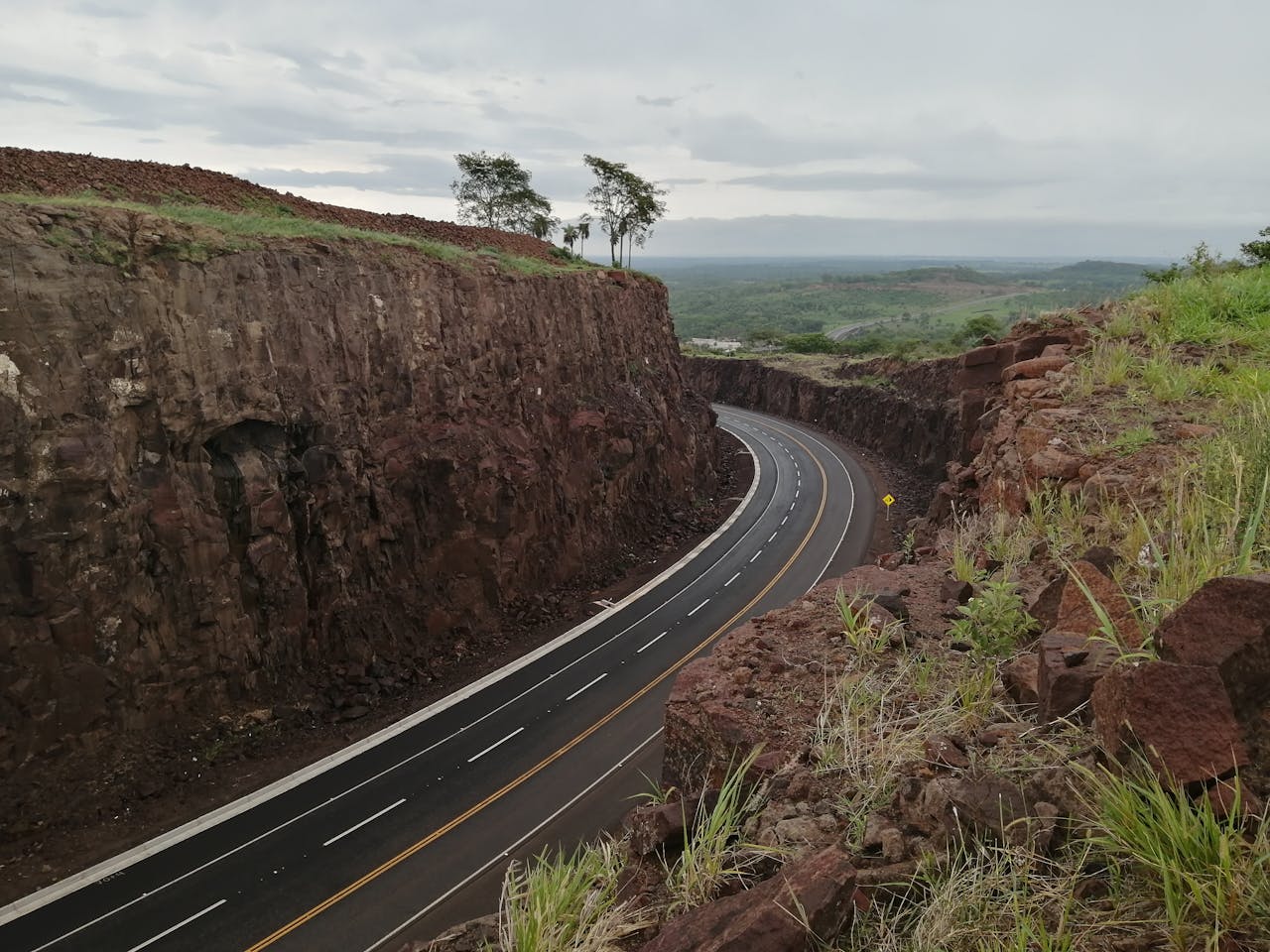 About A captivating aerial view of a winding road through a rocky terrain in Paraguay, showcasing natural beauty.